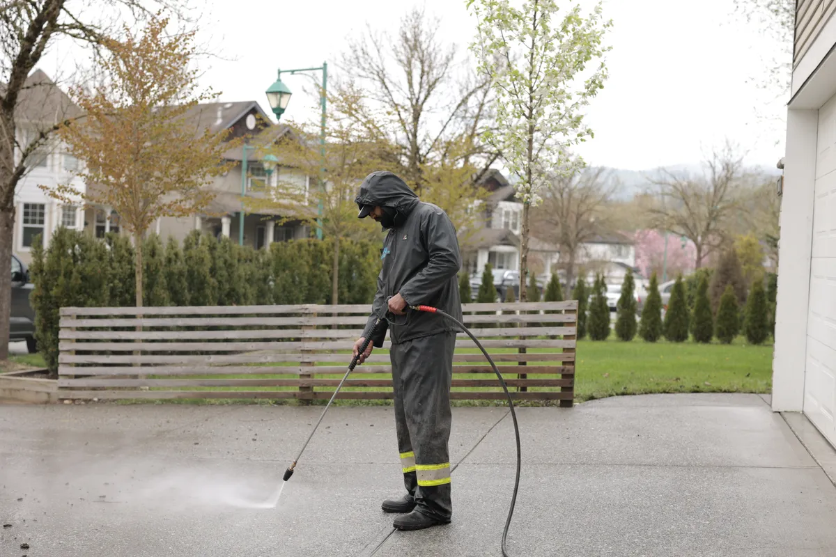 Just Cleaning pressure washing a home driveway