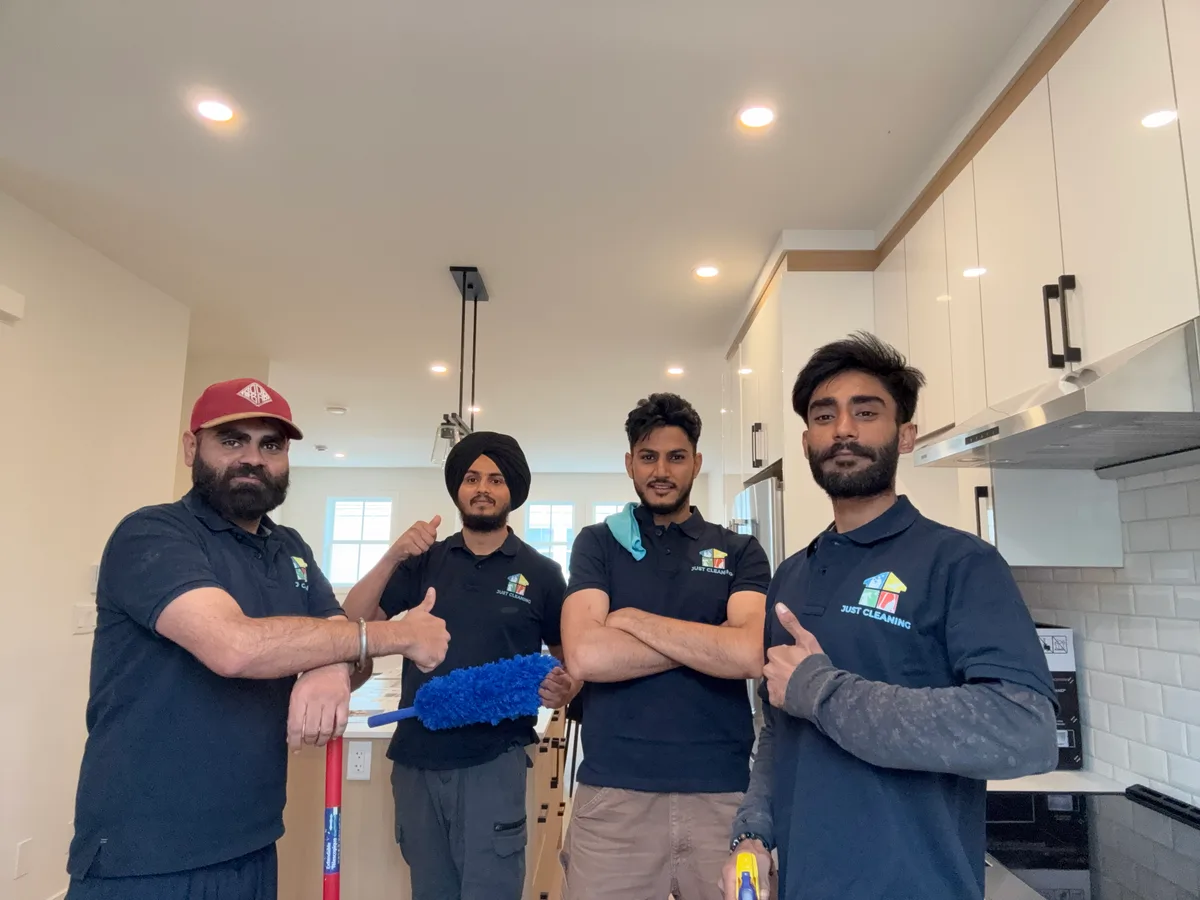 Four members of the Just Cleaning team wearing their branded uniforms